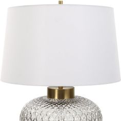 a white lamp with a gold base and a white lampshade on the bottom