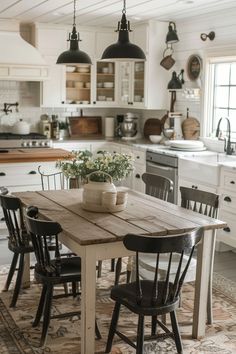 a kitchen table with chairs around it in front of a stove top oven and sink