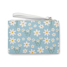 Introducing the Sky Blue Daisy Clutch Bag, a sweet and charming accessory perfect for adding a touch of calm to any outfit. The light blue color and delicate daisy print exude an adorable and pretty vibe, while the addition of white flowers adds a floral touch. Carry this bag to elevate any look with its calming and cute design. Designed with a loop handle to quickly free your hands, this fabulous clutch bag is made for anyone on the go. It can hold everyday essentials such as a phone, wallet, and keys. Carry your lipstick or makeup in here too! It features a zip fastening and a fully lined internal pocket. It is made of vegan leather in the Saffiano pattern finish that was invented by Prada. .: Material: 100% PU faux leather .: One size: 9.5" x 6.6" (24 x 17 cm).: Wrist strap.: Saffiano p Cute Light Blue Bag For Gift, Trendy Blue Floral Print Bags, Cute Blue Bag For Spring, Cute Blue Spring Bag, Bottle Garden, Blue Daisy, Daisy Print, Dress Jewelry, Light Blue Color