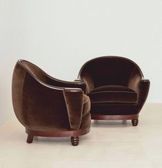 two brown chairs sitting next to each other