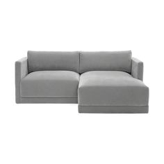 a large gray couch sitting on top of a white floor