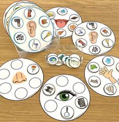 a wooden table topped with lots of paper plates filled with different types of things on them