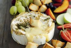 an assortment of fruits and cheeses on a table