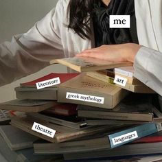 a woman sitting at a table with lots of books on top of her head and the words me, literature, greek mythology, language