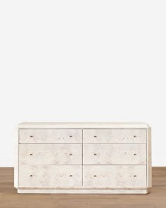 a white dresser sitting on top of a wooden floor