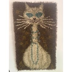 a cat rug hanging on the wall