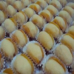 many small pastries are lined up on a table