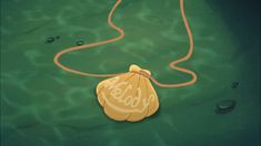 a yellow bag with the word hello written on it is floating in water next to an orange cord