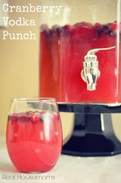 cranberry vodka punch in front of a cake stand with two glasses on it