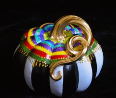 a decorative basket with gold and multicolored decorations