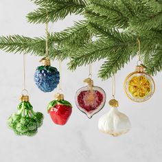 four ornaments hanging from a christmas tree