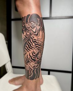 a person with a tattoo on their leg