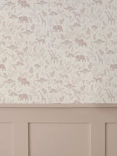 the wall paper has animals on it and is in pastel pink, with white trim