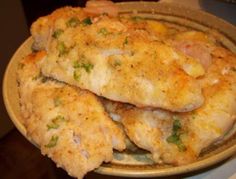 two pieces of chicken in a bowl on a table