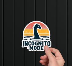 someone is holding up a sticker with the word incognito mode on it