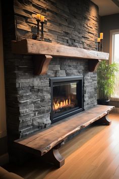 a stone fireplace in a living room next to a window with candles on the mantle