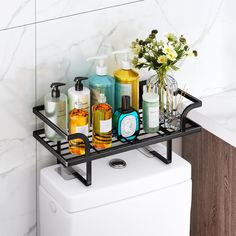 a bathroom shelf with soaps, lotions and bottles on it next to a toilet