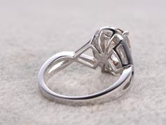 a diamond ring sitting on top of a white carpet