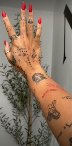 a woman's hand with tattoos on it