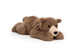 a brown teddy bear laying on its side