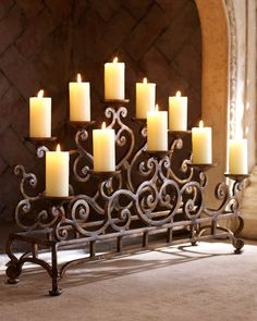 a large metal candle holder with many lit candles