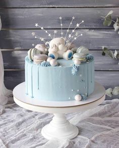 there is a blue cake with white decorations on it