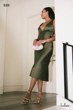 You'll be utterly unparalleled when you arrive in the Lulus Unmatched Elegance Olive Satin Cutout Sleeveless Midi Dress! Glossy woven satin dips low to a V-neckline at the center of a sleeveless bodice with figure-flattering princess seams and a sexy cutout detail at back, secured by a row of upscale covered buttons. High waist sits atop a midi skirt that sways like a dream as you strut across the dancefloor with a drink in hand! Hidden side zipper/clasp. Fit: This garment fits true to size. Length: Knee to mid-calf length. Size medium measures 48" from shoulder to hem. Bust: Great for any cup size. Waist: Fitted - very fitted at natural waist. Hip: Loosely Fitted. Undergarments: May be worn with petals, or no bra. Fabric: Fabric has no stretch. Lined. Shell: 100% Polyester. Lining: 97% Po Olive Green Satin Dress, Spring Graduation Dress, Green Satin Dress, V Neck Midi Dress, Sleeveless Midi Dress, Princess Seams, Dress Satin, Satin Midi Dress, Green Midi Dress