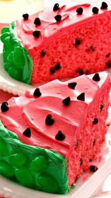 two slices of watermelon cake on white plates with pink napkins and forks