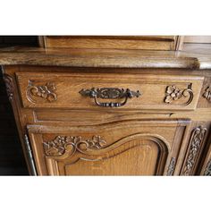 an old wooden dresser with ornate carvings on it