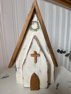 a small wooden church with a cross on it