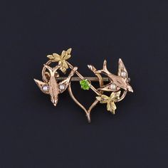 This 10k gold brooch (circa 1890) features two swallows with pearls on their wings and a wishbone adorned with a green glass accent.  The brooch measures 0.7 inches from top to bottom by 0.9 inches wide, and it is in great condition. We have many other fine jewelry items and antique conversion pieces on our Etsy store, so please consider browsing our other items. We send all items in individually packaged gift boxes and offer layaway plans! + Trademark Antiques Shop Homepage https://www.etsy.com Hourglass Pendant, Bespoke Rings, Gold Brooches, Enamel Flower, Antique Shops, 10k Gold, Signet Ring, Earring Necklace, Jewelry Findings