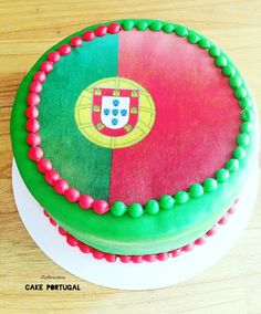 there is a cake decorated with the flag of portugal and green, red and yellow