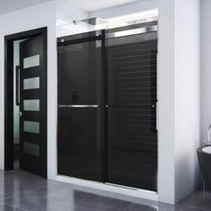 a black and white bathroom with a glass shower door