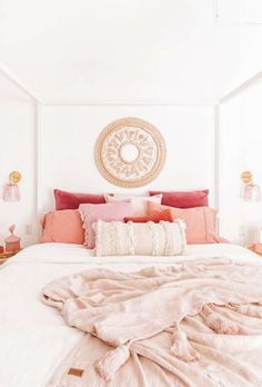 a white bed topped with pillows and blankets