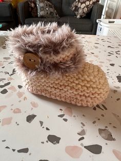 a knitted slipper sitting on top of a table