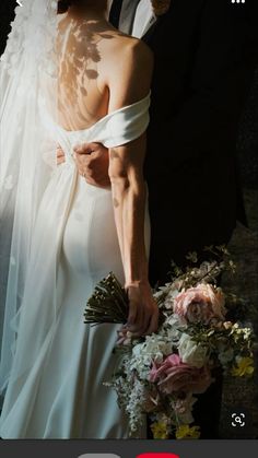 a bride and groom standing next to each other