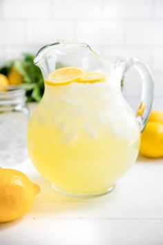 a pitcher filled with lemonade sitting on top of a counter