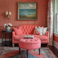 a living room with red walls and pink furniture in the corner, along with a painting on the wall