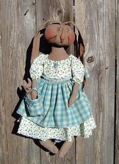 a doll is hanging on a wooden fence