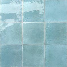 a blue tiled wall with white grouting