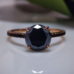 a black diamond ring sitting on top of a table