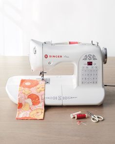 a sewing machine sitting on top of a wooden table