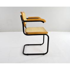 an image of a chair that is made out of wicker and metal frame with yellow seat padding