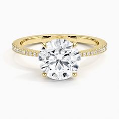 a yellow gold engagement ring with diamonds on the band