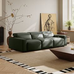 a living room with a couch, coffee table and painting on the wall behind it