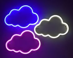 three neon clouds sitting on top of a table