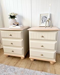 two white dressers sitting next to each other on top of a wooden floor