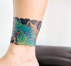 a woman's foot with a fish tattoo on the side of her leg and red eyes