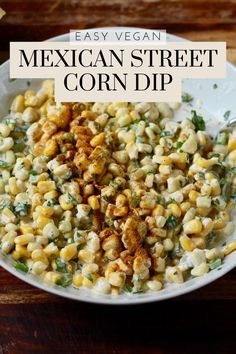 mexican street corn dip in a white bowl on a wooden table with text overlay that reads easy vegan mexican street corn dip