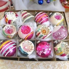 a box filled with assorted ornaments on top of a table